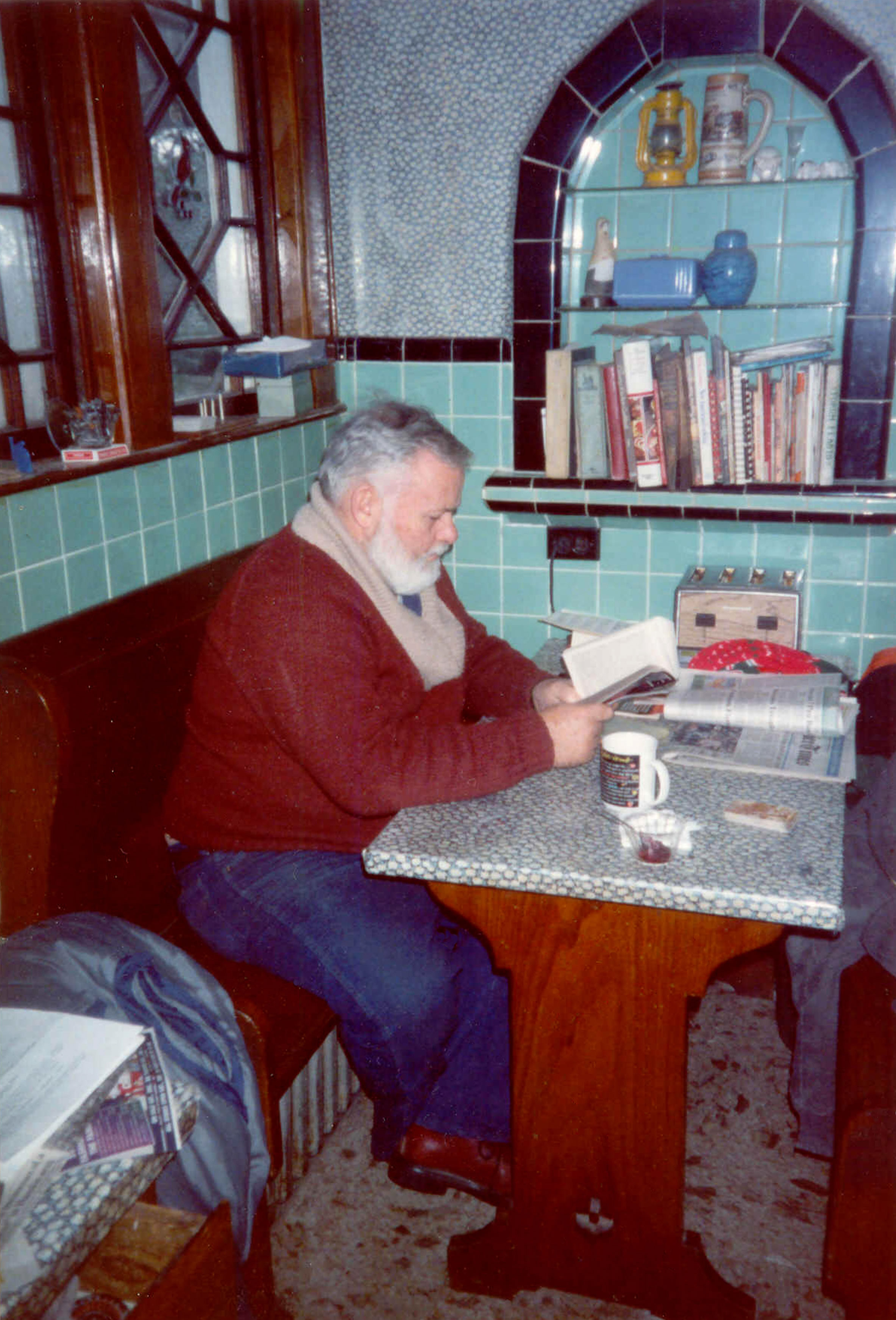 Bud Rue reading in the breakfast nook