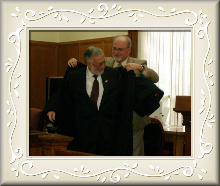 Hon. Stephan Schick holds Hon. Burton Ledina's robe